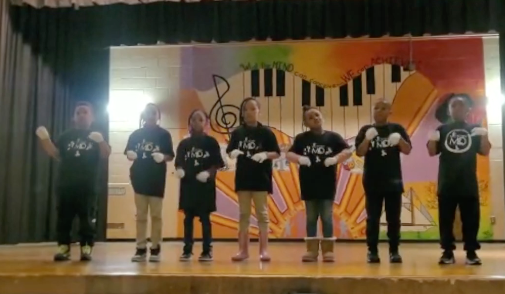 group of students dancing on stage